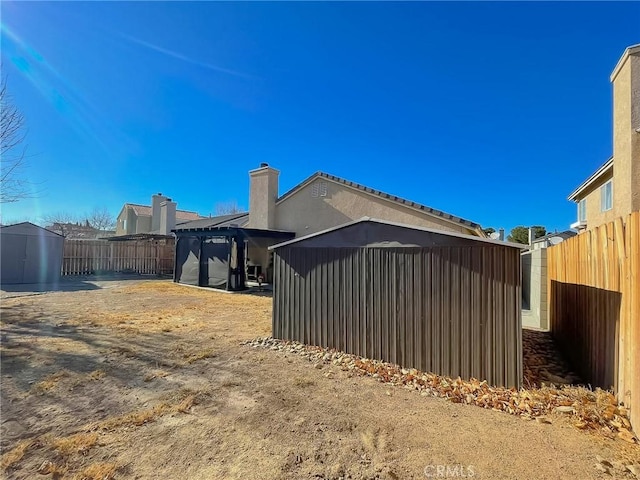 view of side of property featuring a fenced backyard