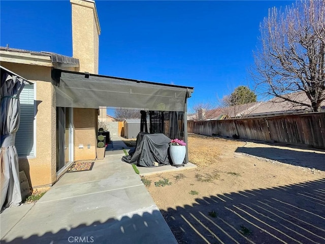 view of yard featuring a patio area and a fenced backyard