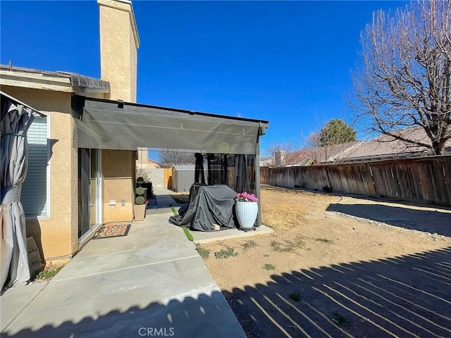 exterior space with a fenced backyard and a patio area