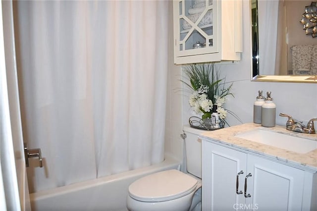 full bath with toilet, shower / bath combo with shower curtain, and vanity