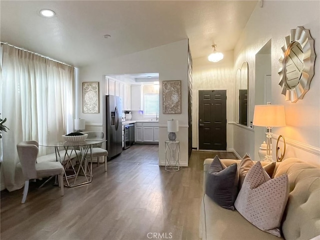 living room with vaulted ceiling and wood finished floors