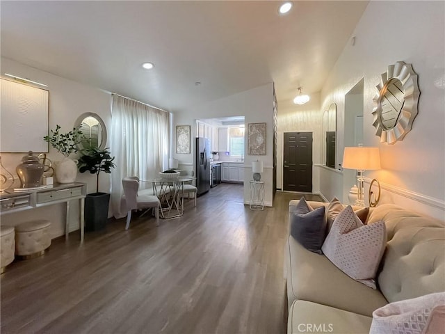 living area with dark wood-style floors, recessed lighting, and vaulted ceiling