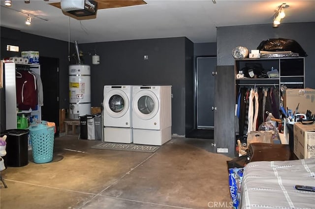 interior space with separate washer and dryer, secured water heater, and a garage door opener