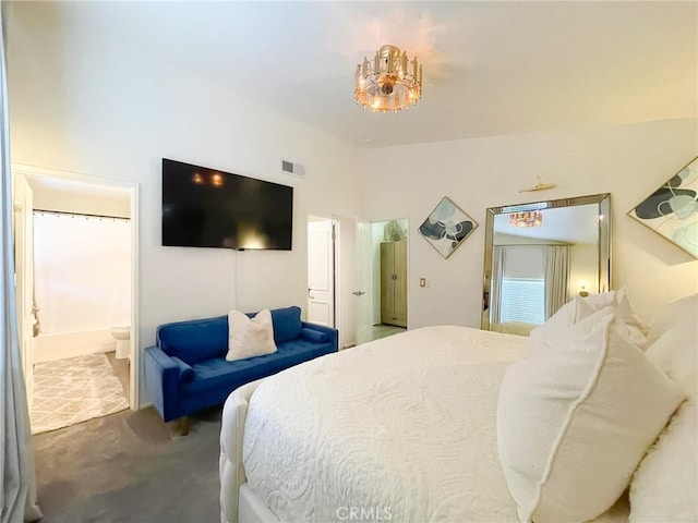 carpeted bedroom featuring visible vents, vaulted ceiling, and ensuite bath