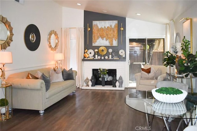 living room with lofted ceiling, dark wood-style flooring, a fireplace, and recessed lighting