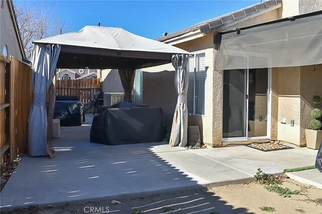 view of patio featuring fence, a gazebo, and area for grilling