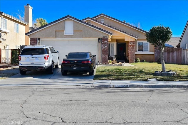 ranch-style home with a garage and a front lawn