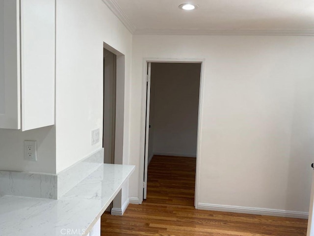 interior space with ornamental molding and wood-type flooring