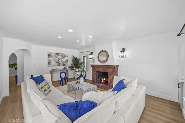 living room featuring light hardwood / wood-style floors and a fireplace