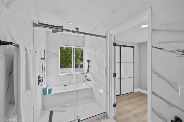 bathroom featuring hardwood / wood-style floors and independent shower and bath