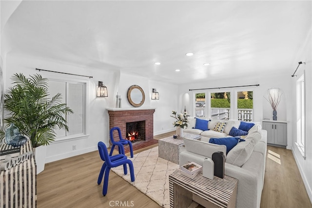 living room with a fireplace and light hardwood / wood-style floors