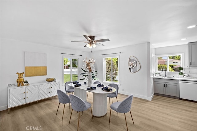 dining room with light wood-type flooring and sink