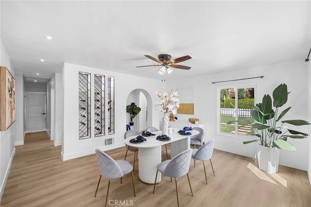 dining room with ceiling fan and light hardwood / wood-style floors