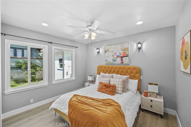 bedroom with ceiling fan and hardwood / wood-style floors