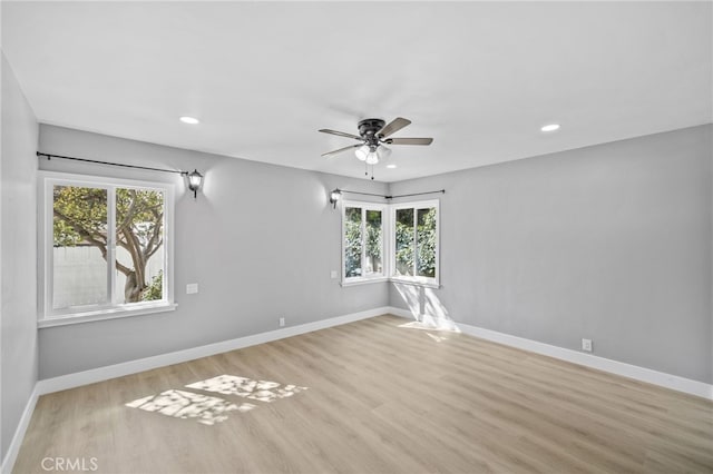 unfurnished room with ceiling fan and light wood-type flooring