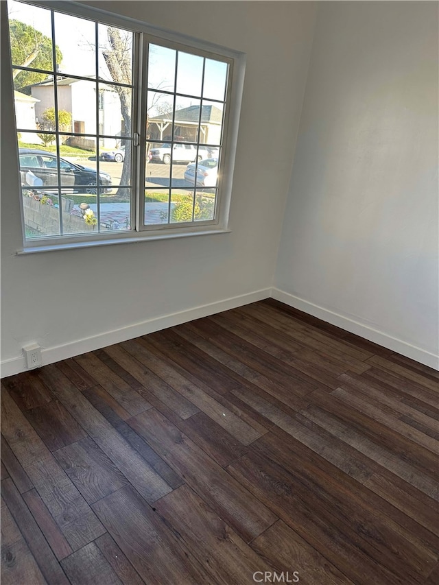 spare room featuring dark wood-type flooring