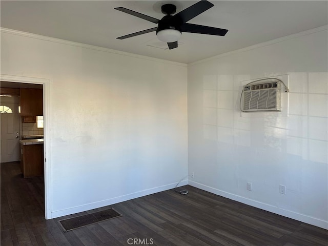 spare room with ceiling fan, an AC wall unit, dark hardwood / wood-style floors, and crown molding