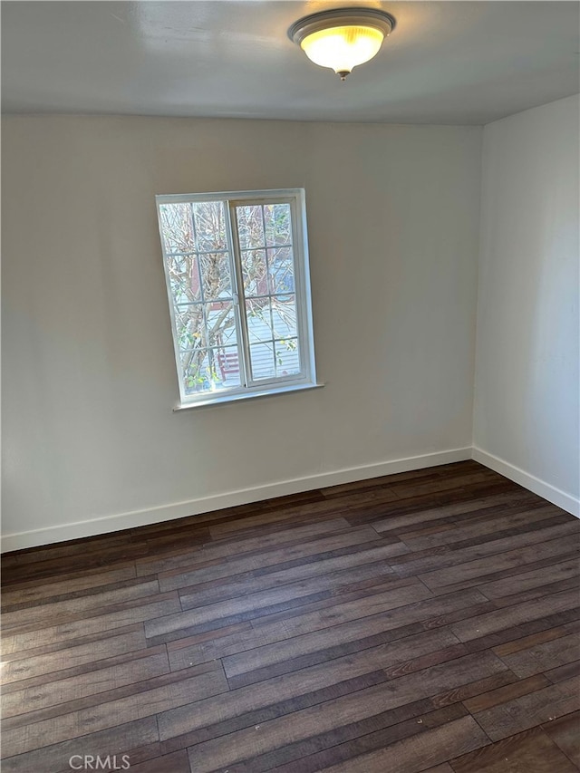 unfurnished room with dark hardwood / wood-style floors