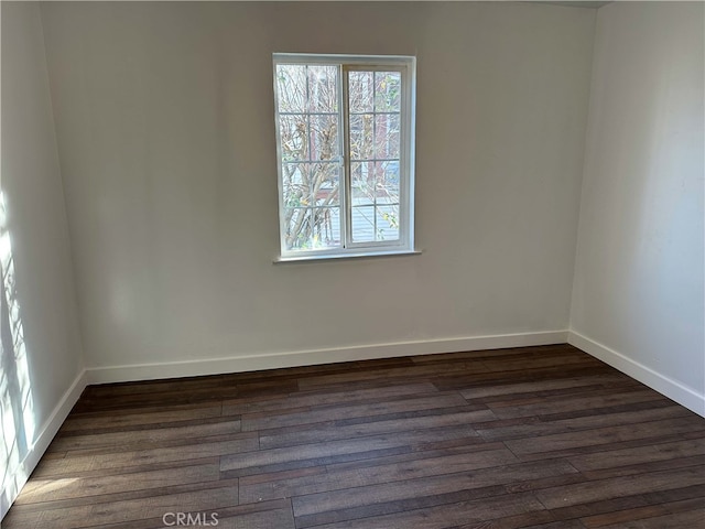 empty room featuring dark wood-type flooring