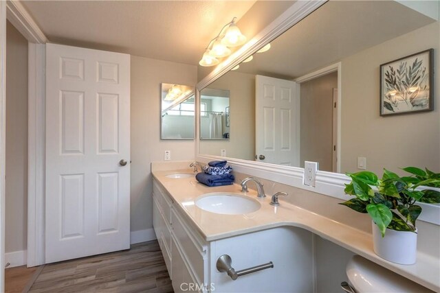 bathroom with hardwood / wood-style floors and vanity