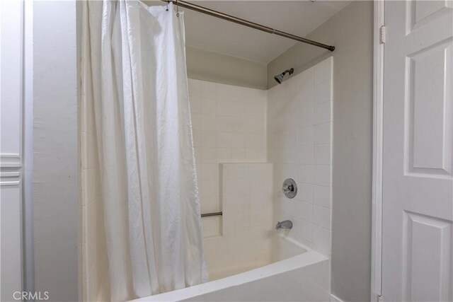 bathroom with shower / bath combo with shower curtain