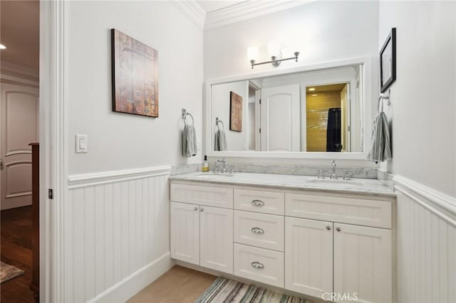 bathroom featuring crown molding and vanity