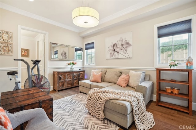 living area with crown molding and hardwood / wood-style floors