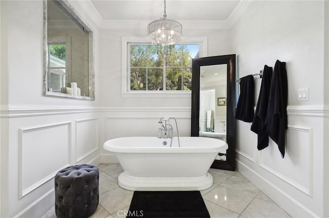 bathroom featuring a chandelier, ornamental molding, and a bath