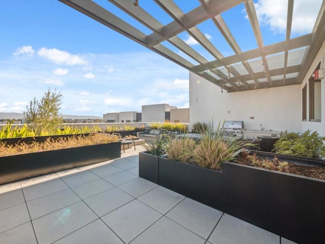 view of patio with an outdoor kitchen and a pergola