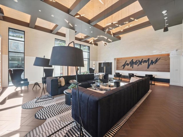 living room with parquet floors, beam ceiling, and a wealth of natural light