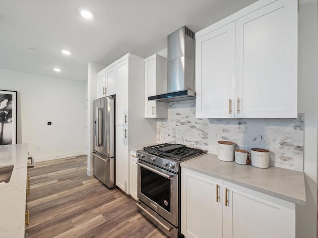 kitchen with white cabinetry, wall chimney exhaust hood, and appliances with stainless steel finishes