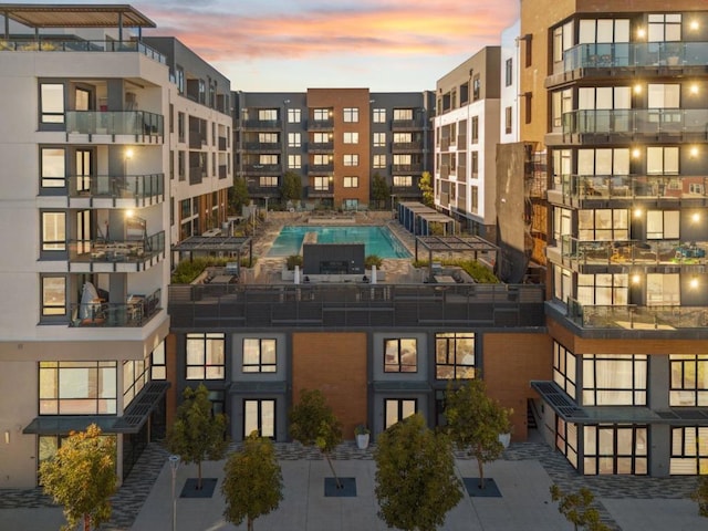 outdoor building at dusk with a community pool