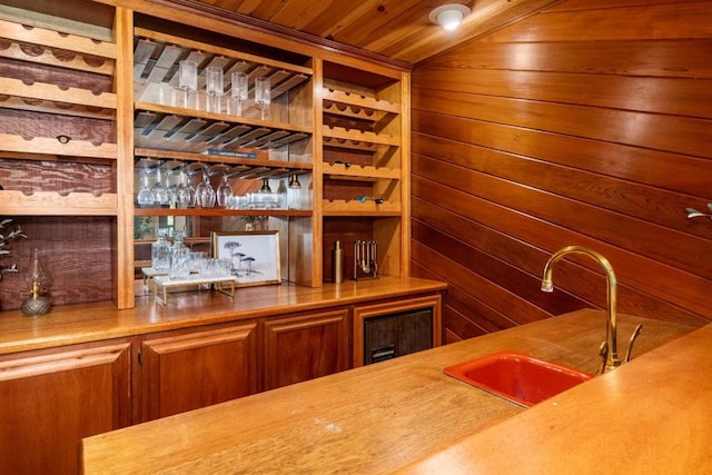 bar with wood ceiling, wooden walls, and sink