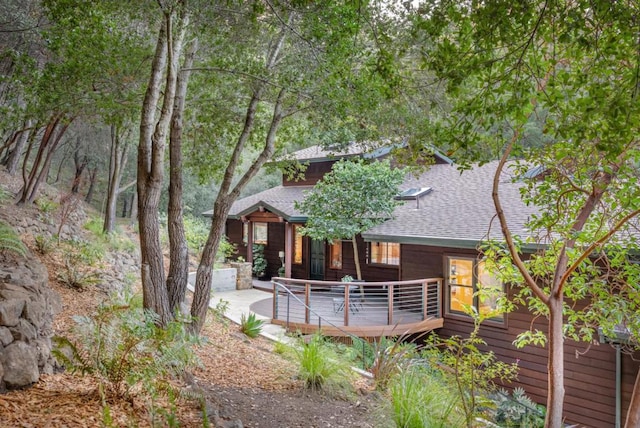 back of property featuring a wooden deck