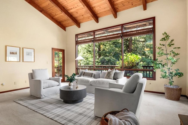 living room featuring beamed ceiling, light colored carpet, wooden ceiling, and high vaulted ceiling