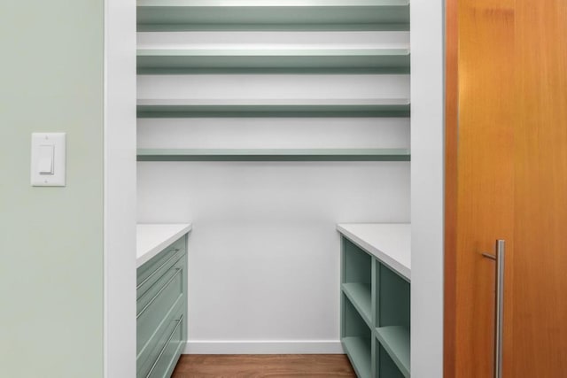 walk in closet featuring dark hardwood / wood-style flooring