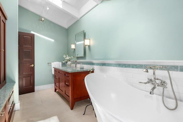 bathroom with vanity, a tub, and tile patterned floors