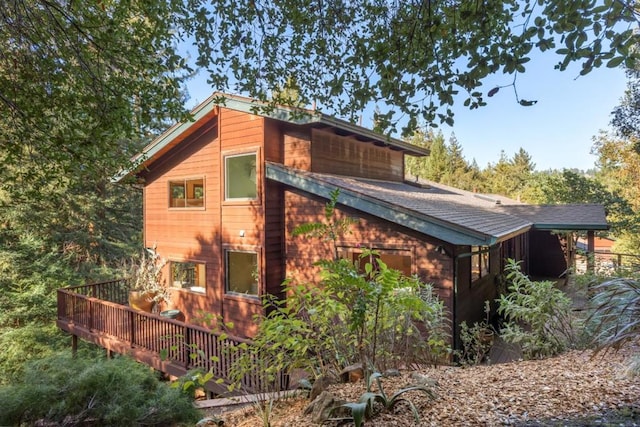 view of property exterior featuring a deck