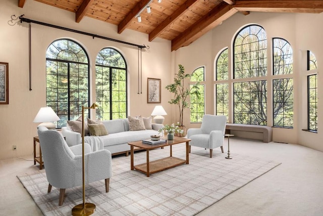 sunroom / solarium with wood ceiling, plenty of natural light, and vaulted ceiling with beams