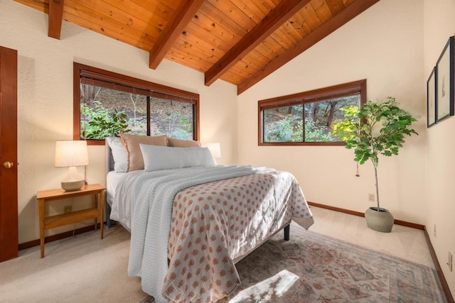 carpeted bedroom featuring multiple windows, vaulted ceiling with beams, and wood ceiling