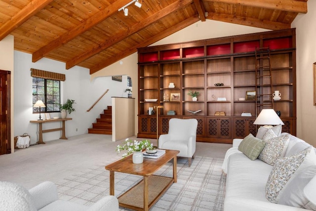 carpeted living room with lofted ceiling with beams and wooden ceiling