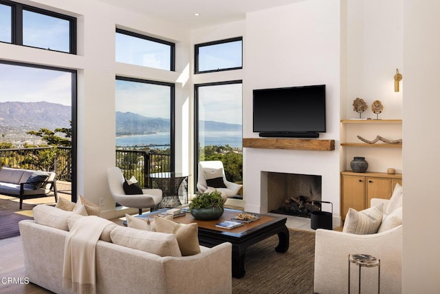 living room with a mountain view, plenty of natural light, and a towering ceiling