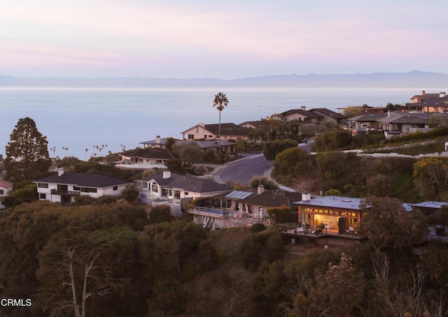 aerial view at dusk featuring a mountain view