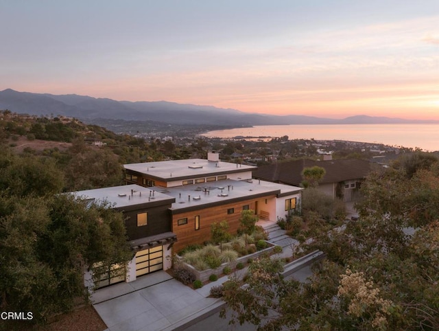 aerial view at dusk featuring a mountain view