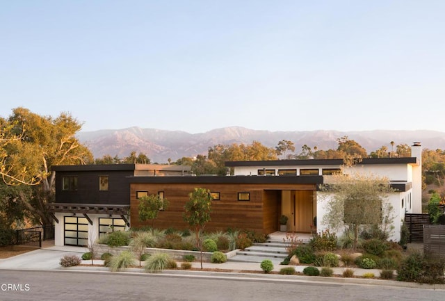 view of front facade featuring a mountain view and a garage