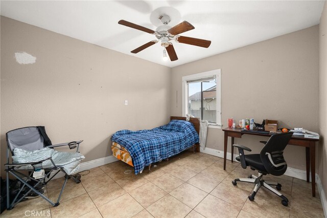 bedroom with ceiling fan and light tile patterned flooring