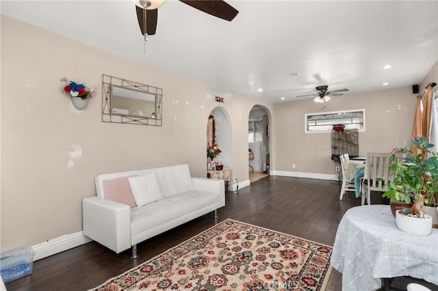 living room with dark hardwood / wood-style floors and ceiling fan