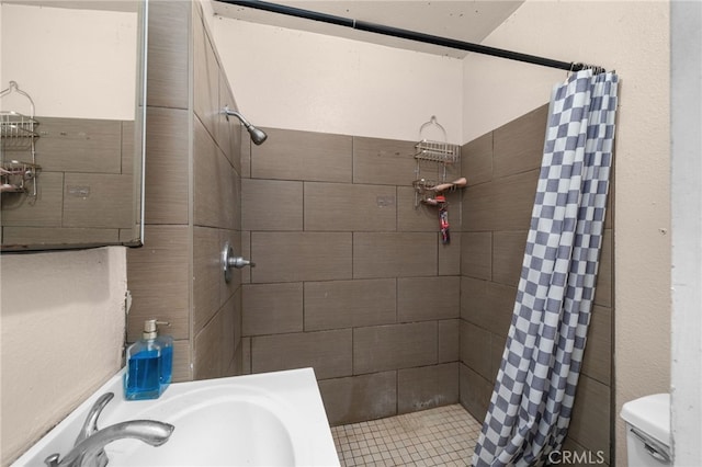 bathroom featuring sink, toilet, and walk in shower