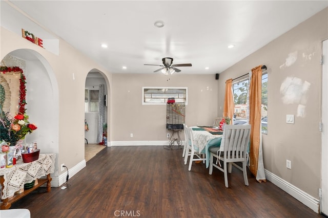 dining space with dark wood-type flooring and ceiling fan