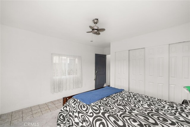 bedroom with ceiling fan and a closet